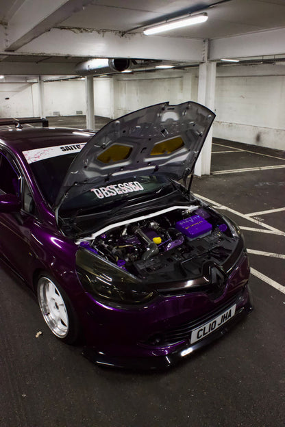 Purple Renault Clio with bonnet open and white Obsessed cherry blossom windscreen banner