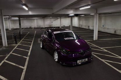 Purple Renault Clio in a car park with a white Obsessed cherry blossom windscreen banner