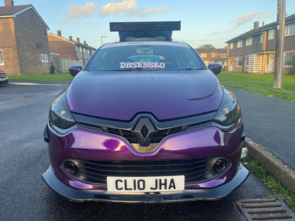 Front view of purple Renault Clio with white Obsessed cherry blossom windscreen banner