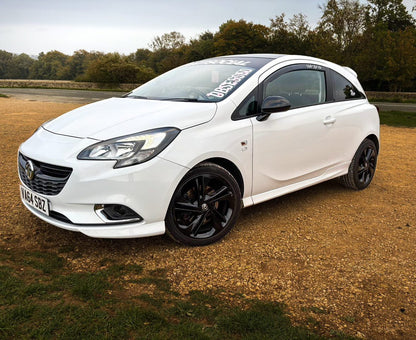 White Vauxhall Corsa displaying a white Obsessed cherry blossom windscreen banner