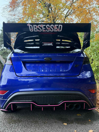 White Obsessed cherry blossom sticker fitted to the rear spoiler of a blue Ford Fiesta