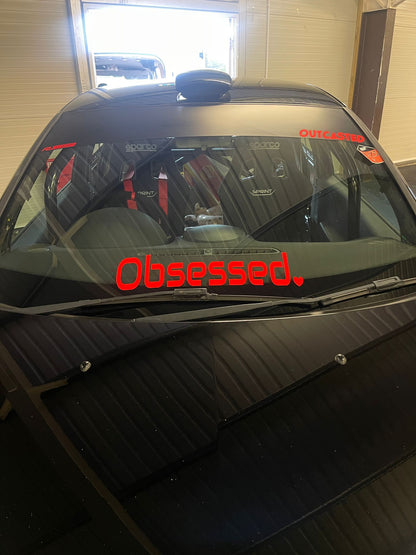 Front view of black car with red Obsessed heart windscreen banner