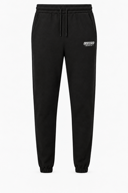 Black OBSESSED embroidered joggers with white logo and gathered ankle cuffs