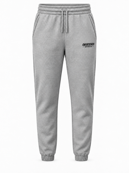 Heather grey OBSESSED embroidered joggers with black logo and gathered ankle cuffs