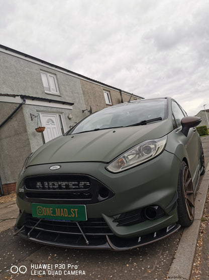 Matte green Ford Fiesta photographed from the front