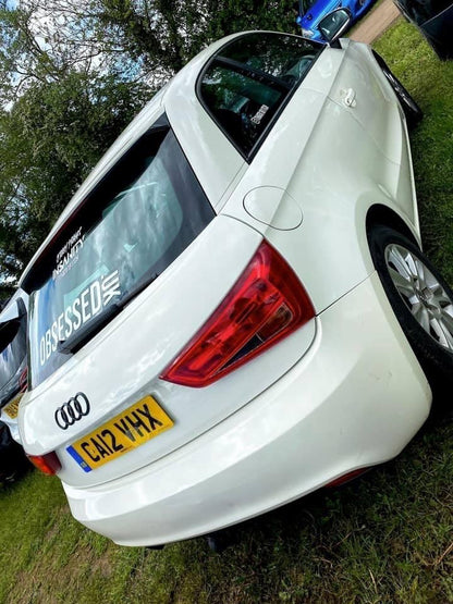 White 550mm Obsessed.uk decal fitted to the rear window of a white Audi