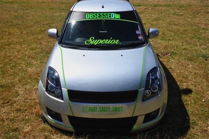 Silver Suzuki Swift with green @THAT.SASSY.SWIFT front show plate
