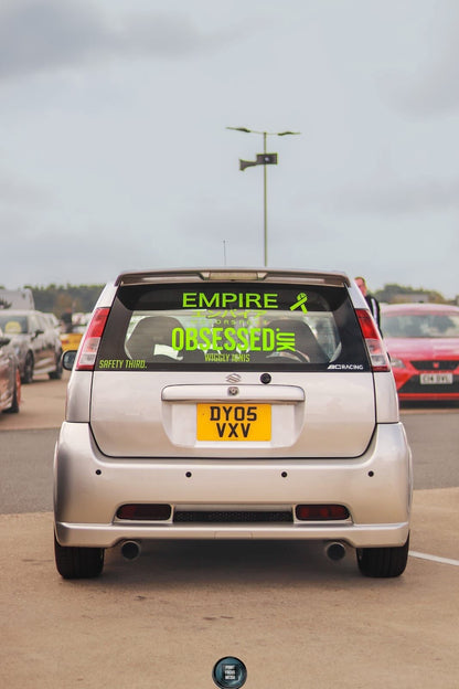 Bright green glitter 550mm Obsessed.uk decal fitted to the rear window of a silver car